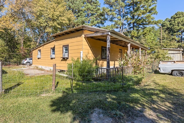 view of side of property with a yard