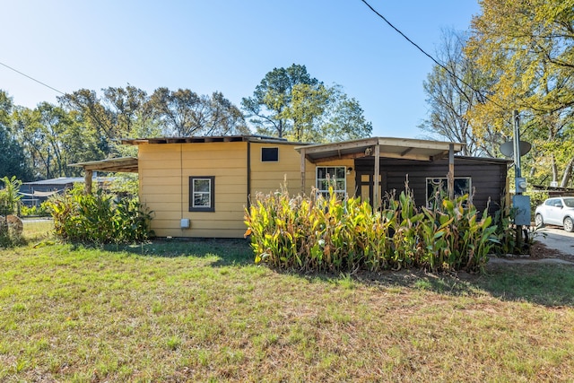 rear view of property with a yard