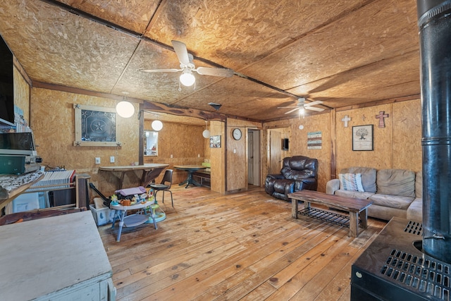 living room with wood-type flooring and wooden walls