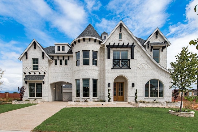 view of front of home featuring driveway, a front lawn, and brick siding