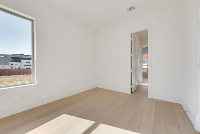 unfurnished room with light wood-type flooring