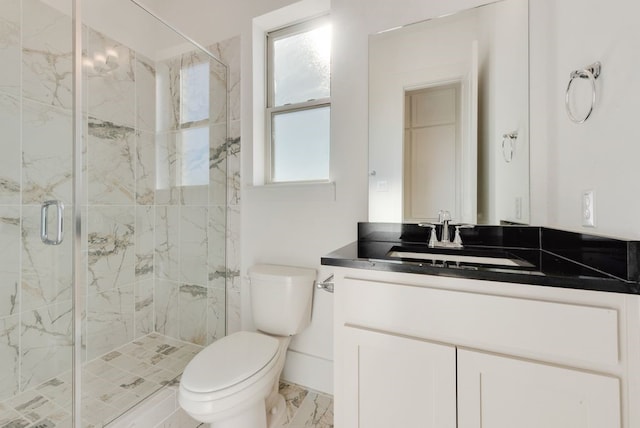 bathroom with vanity, toilet, and a shower with shower door