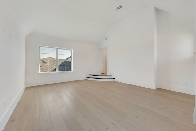 unfurnished living room with high vaulted ceiling and light hardwood / wood-style floors