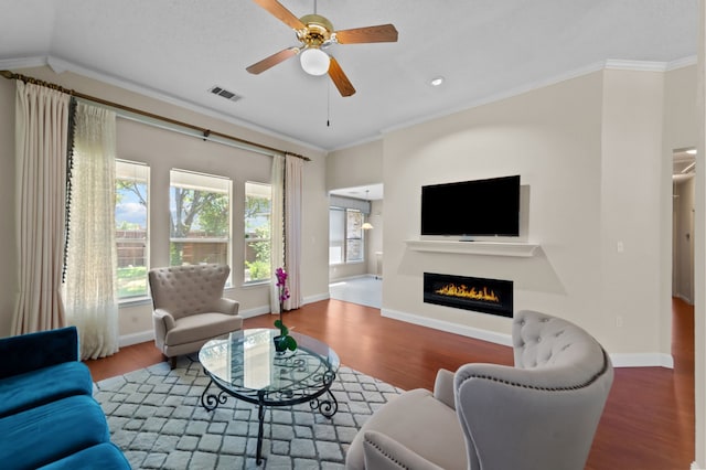 living room featuring crown molding, hardwood / wood-style floors, ceiling fan, and vaulted ceiling