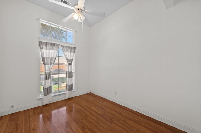 empty room featuring hardwood / wood-style floors and ceiling fan