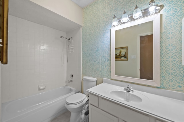 full bathroom with toilet, vanity, and tiled shower / bath