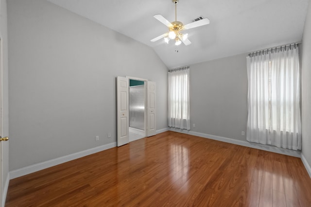 spare room with ceiling fan, wood-type flooring, and vaulted ceiling