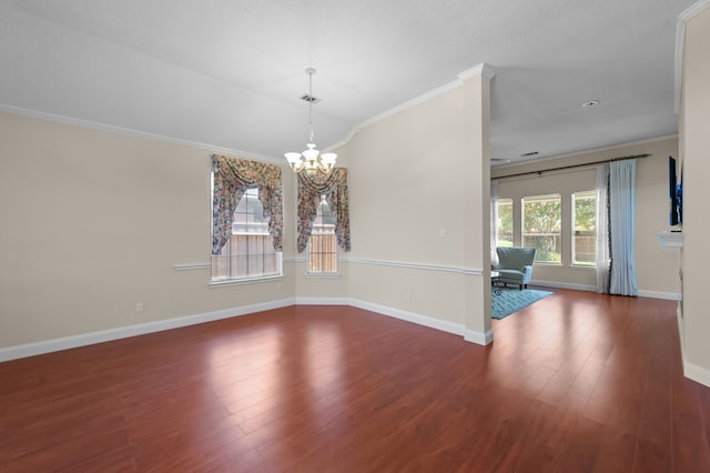 unfurnished dining area featuring ornamental molding, dark wood-type flooring, and an inviting chandelier