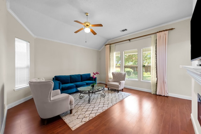 living room with ceiling fan, crown molding, wood-type flooring, and lofted ceiling