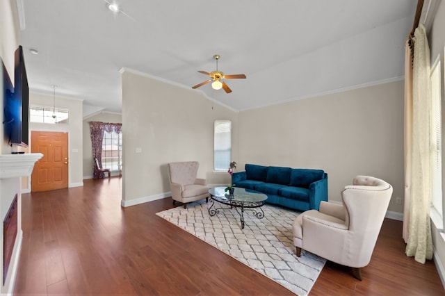 living room with ceiling fan, dark hardwood / wood-style flooring, crown molding, and vaulted ceiling