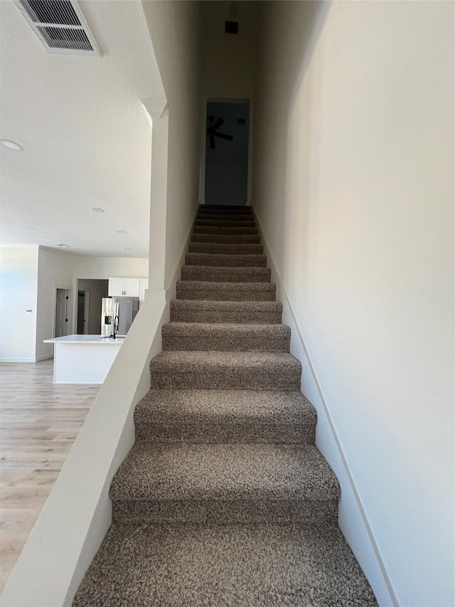 stairs with wood-type flooring