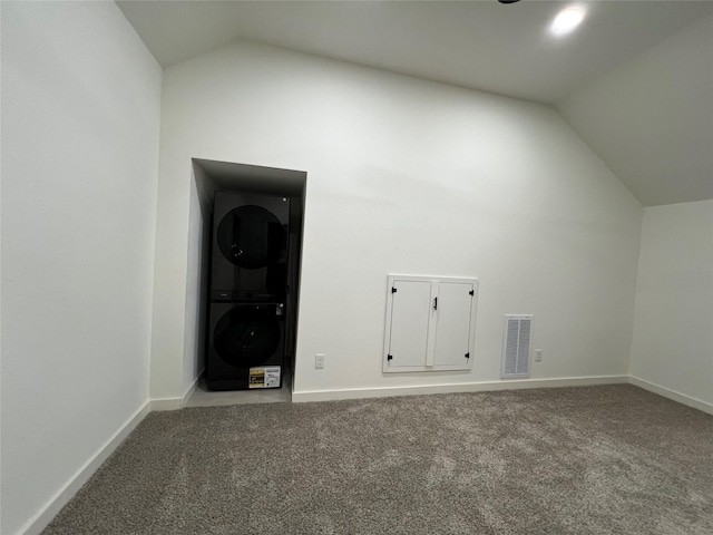 bonus room featuring carpet flooring, lofted ceiling, and stacked washer / dryer