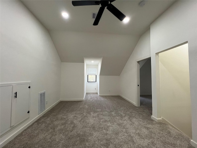 additional living space featuring ceiling fan, carpet, and lofted ceiling