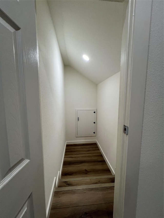 stairway with hardwood / wood-style flooring and vaulted ceiling