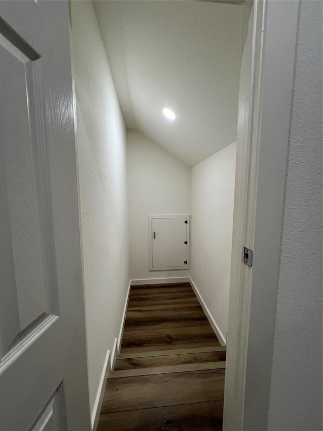 stairs with vaulted ceiling and hardwood / wood-style floors