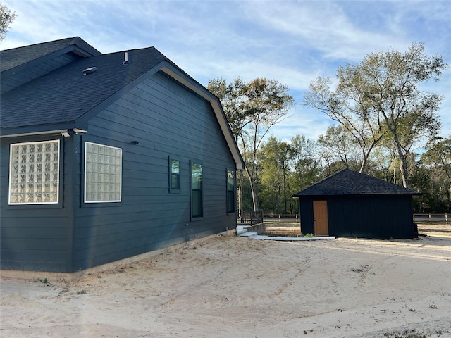 view of property exterior with an outbuilding