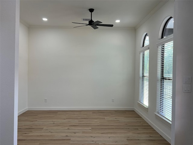 unfurnished room featuring ceiling fan, light wood-type flooring, and crown molding