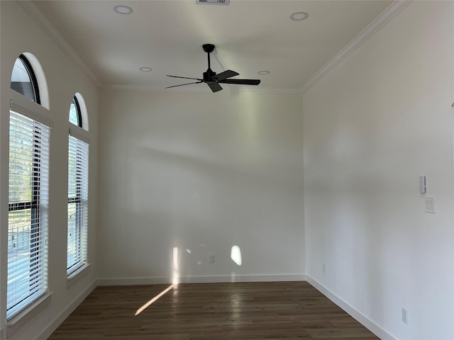 empty room featuring crown molding, ceiling fan, and dark wood-type flooring