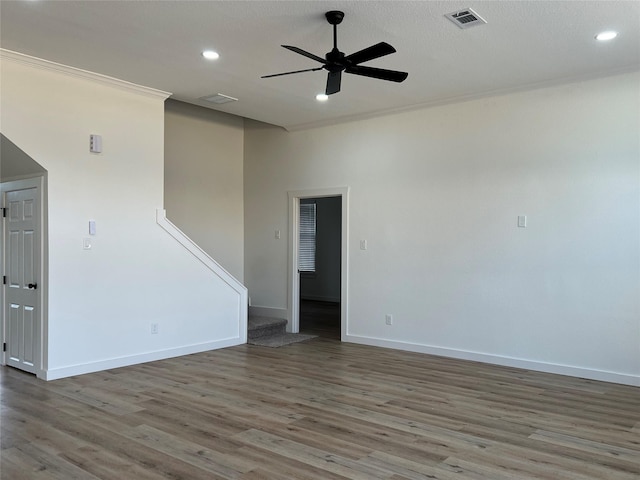 unfurnished room featuring ceiling fan, crown molding, a textured ceiling, and hardwood / wood-style flooring