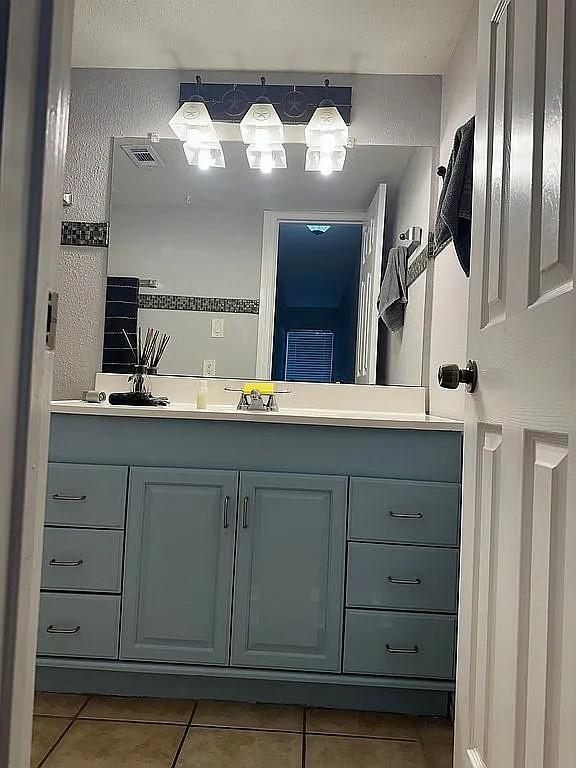 bathroom featuring tile patterned flooring and vanity