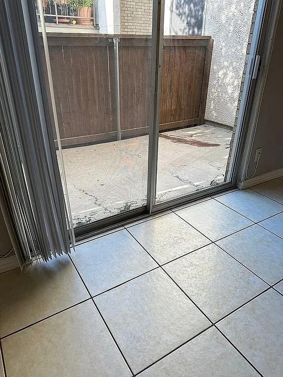 doorway to outside featuring light tile patterned flooring