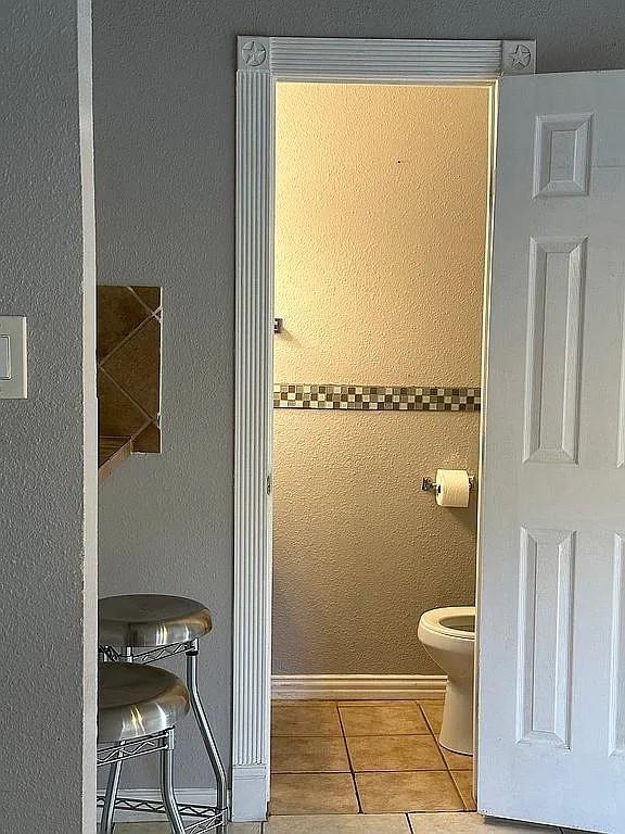 bathroom featuring tile patterned floors and toilet