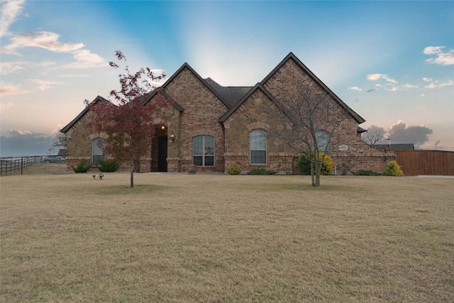 french provincial home featuring a yard