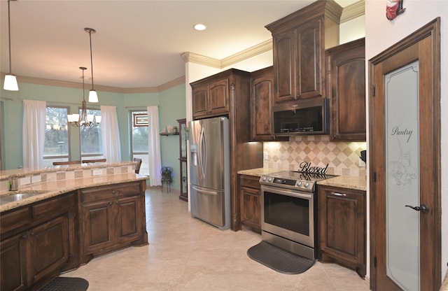 kitchen with an inviting chandelier, sink, hanging light fixtures, appliances with stainless steel finishes, and dark brown cabinetry