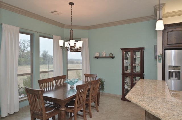 dining area with ornamental molding and an inviting chandelier