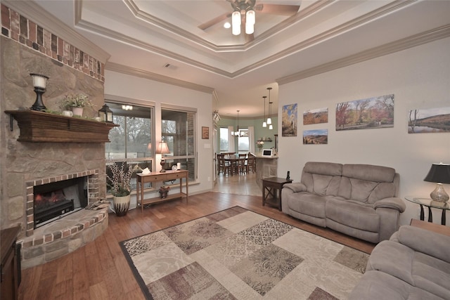 living room with ceiling fan, plenty of natural light, and wood-type flooring