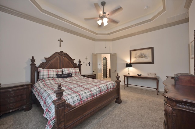 carpeted bedroom with a raised ceiling, ceiling fan, and ornamental molding