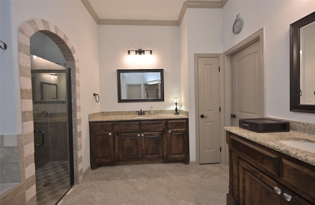 bathroom featuring tile patterned flooring, vanity, a shower with door, and crown molding