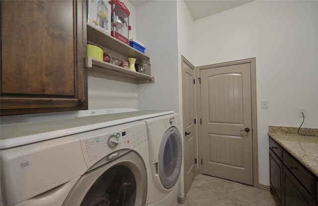 laundry area with cabinets, washer and clothes dryer, and light tile patterned flooring