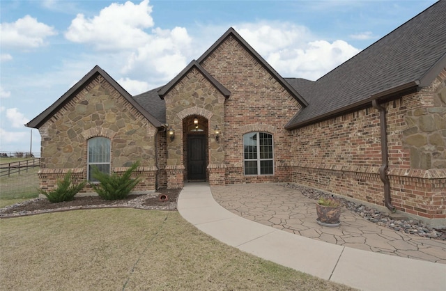 french provincial home featuring a patio area and a front yard