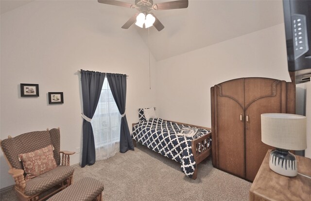 carpeted bedroom featuring ceiling fan and vaulted ceiling