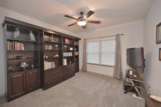 interior space with ceiling fan and light colored carpet