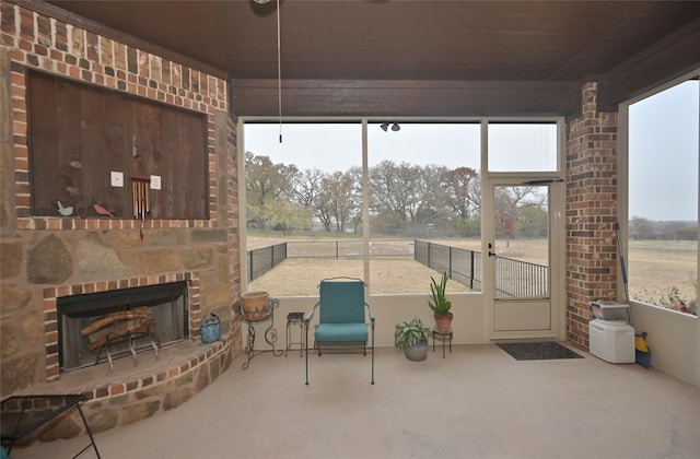 sunroom featuring an outdoor brick fireplace