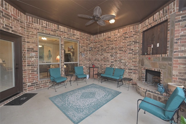 view of patio / terrace with an outdoor brick fireplace and ceiling fan