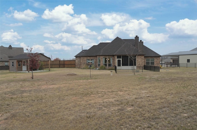 rear view of house with a yard