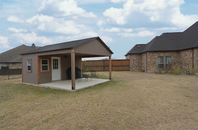 rear view of property with a yard and a patio