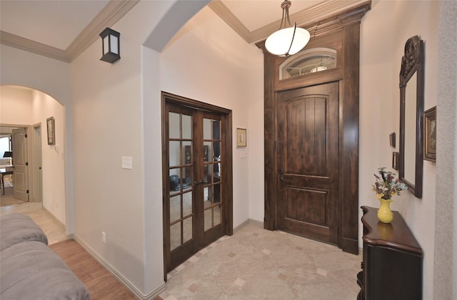 entryway featuring french doors, light hardwood / wood-style flooring, and ornamental molding