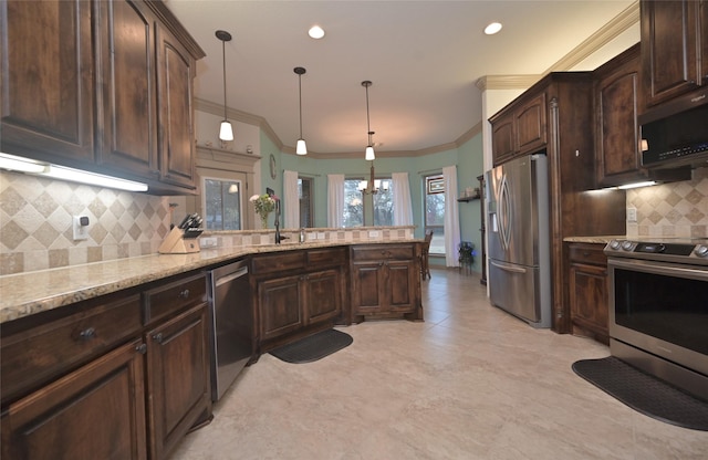 kitchen with tasteful backsplash, dark brown cabinets, stainless steel appliances, crown molding, and hanging light fixtures