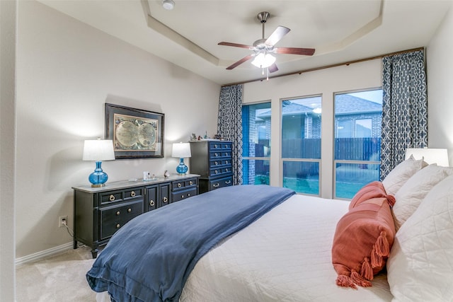 3308 Estacado Dr, Denton, TX 76210 - bedroom with baseboards, a tray ceiling, a ceiling fan, and light colored carpet