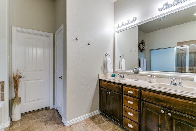 3308 Estacado Dr, Denton, TX 76210 - full bath with double vanity, an enclosed shower, visible vents, and a sink