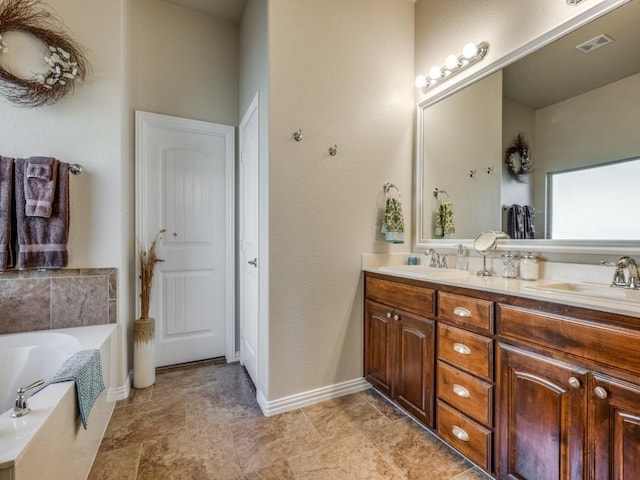 bathroom featuring a washtub and vanity