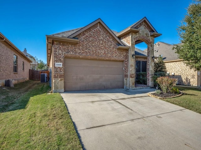 view of front property featuring a garage, central AC, and a front yard