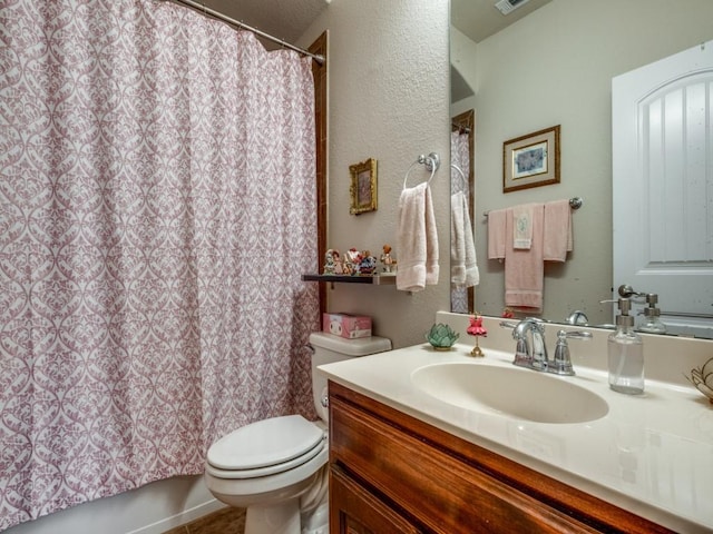 full bathroom featuring vanity, shower / bath combo, and toilet