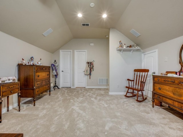 sitting room featuring light colored carpet and lofted ceiling