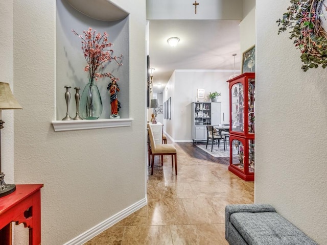 corridor featuring crown molding