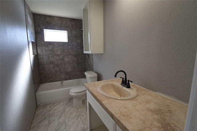 bathroom with vanity, toilet, a textured wall, and shower / bath combination